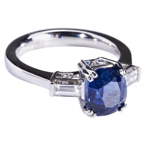 290 - A SAPPHIRE AND DIAMOND RINGthe cushion-cut sapphire four double claw set between baguette-cut diamon... 