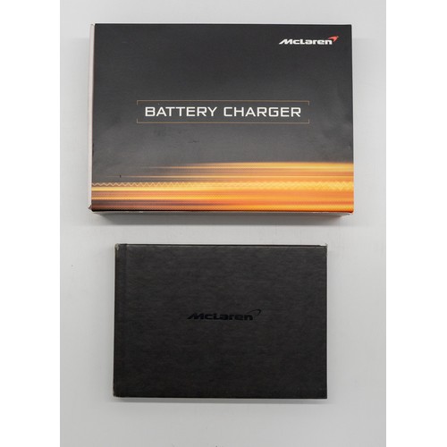 340 - MCLAREN MP4-12C HANDBOOK AND BATTERY CHARGERA new owners Handbook for the legendary MP4-12C together... 