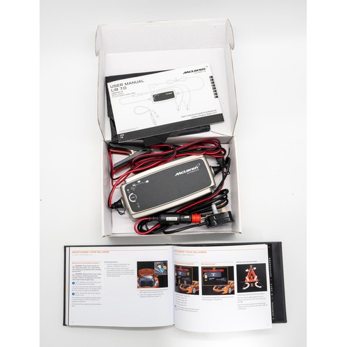 340 - MCLAREN MP4-12C HANDBOOK AND BATTERY CHARGERA new owners Handbook for the legendary MP4-12C together... 