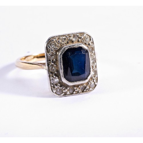 285 - A SAPPHIRE AND DIAMOND PLAQUE RING, CIRCA 1940the cushion-cut sapphire collet set within a diamond s... 