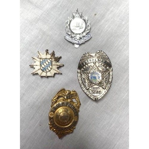 70 - OVER 50 US AND GERMAN POLICE BADGES Over 50 sew-on and cast metal badges covering many US cities, co... 