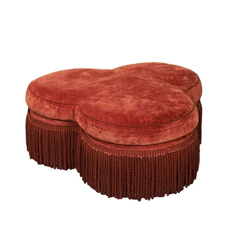 496 - A TREFOIL FORM PADDED CENTRE STOOL, LATE 20TH CENTURY, covered in a burnt orange velvet above a red ... 