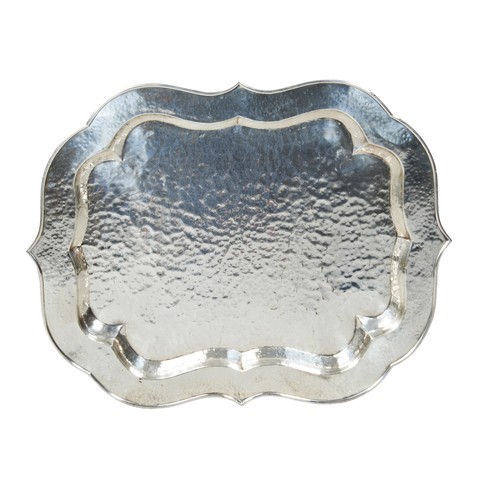 778 - A CHROMED SCROLL EDGE TRAY, 20TH CENTURY, escutcheon shape with planished finish, raised on a foldin... 