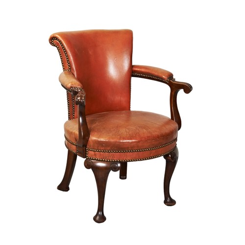 513 - A TAN LEATHER UPHOLSTERED LIBRARY CHAIR,  tapering back panel over a circular padded seat, flanked b... 