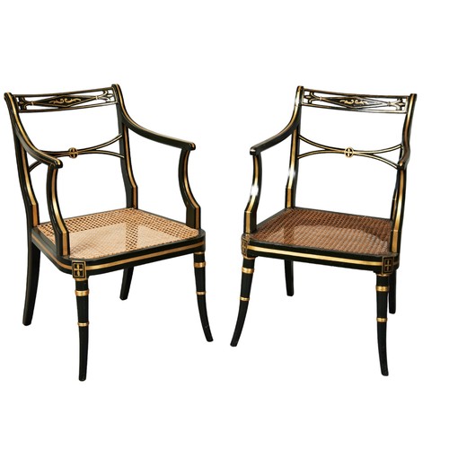 517 - A PAIR OF DARK GREEN AND PARCEL GILT PAINTED ELBOW CHAIRS, with caned seat panels and loose squab cu... 