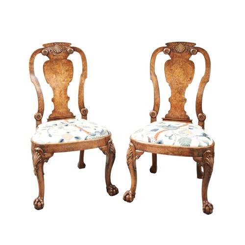 524 - A PAIR OF GEORGE II STYLE WALNUT CHAIRS shell carved top rail above a vasiform splat flanked by scro... 