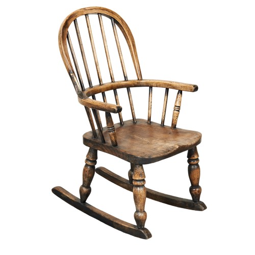 525 - A CHILD'S COMB BACK WINDSOR ROCKING CHAIR raised on baluster ring turned supports.71cm x 41cm x 53cm... 