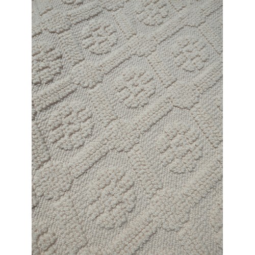 614 - A CONTEMPORARY CREAM COLOUR LATTICE EMBOSSED STARK RUGProvenance: From The Private Collection of the... 