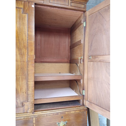 528 - A 19TH CENTURY MAHOGANY LINEN PRESS, two panelled doors over an arrangement of two short and two lon... 