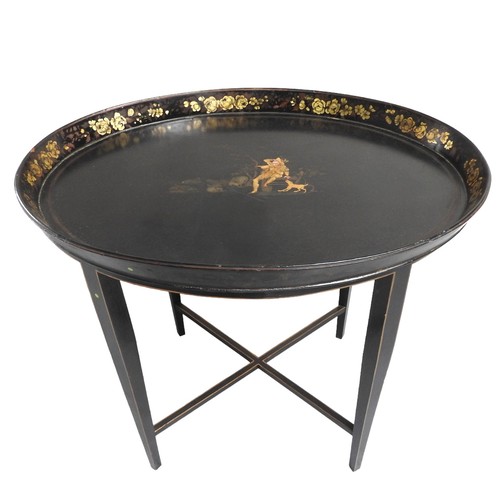 532 - A VINTAGE OVAL TRAY TOP TABLE the oval top painted with a rural scene depicting shepherd, the galler... 