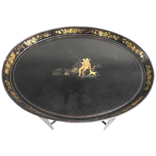 532 - A VINTAGE OVAL TRAY TOP TABLE the oval top painted with a rural scene depicting shepherd, the galler... 