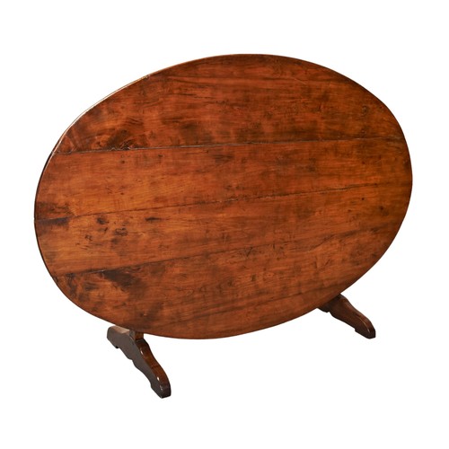 537 - AN OVAL TOP TILTING CONTINENTAL FRUIT WOOD COUNTRY TABLE The oval form plank top raised on a refecto... 