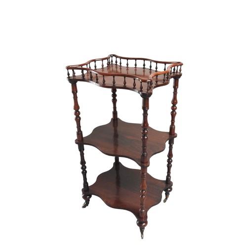 544 - A ROSEWOOD WHATNOT, 19TH CENTURY rectangular undulating form, the galleried top with two undershelve... 