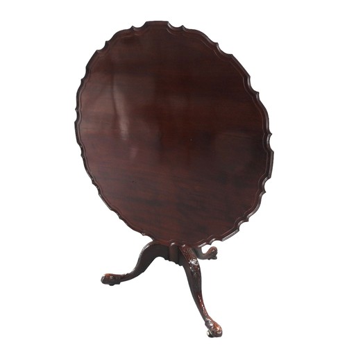 548 - A VINTAGE MAHOGANY TRIPOD TABLE the circular tilting pie crust edged top raised on a fluted tapering... 