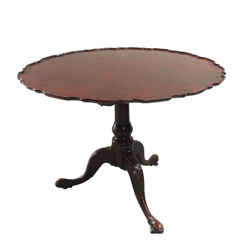 548 - A VINTAGE MAHOGANY TRIPOD TABLE the circular tilting pie crust edged top raised on a fluted tapering... 