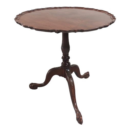 549 - A VINTAGE MAHOGANY TRIPOD TABLE the circular tilting scroll edge top on a fluted baluster pillar rai... 