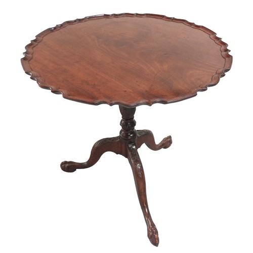 549 - A VINTAGE MAHOGANY TRIPOD TABLE the circular tilting scroll edge top on a fluted baluster pillar rai... 