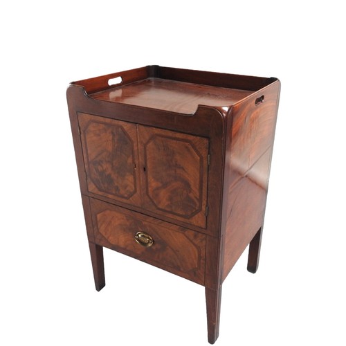 554 - A MAHOGANY PANELLED NIGHT COMMODE the three quarter galleried tray top above line inlaid cupboard do... 