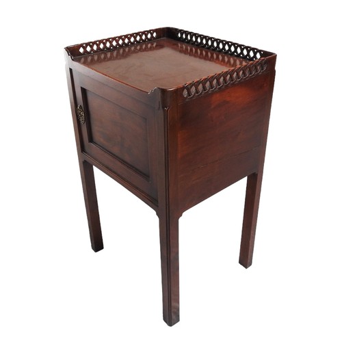 560 - 19TH CENTURY MAHOGANY NIGHT COMMODE with a three quarter pierced latticed gallery edged tray top abo... 