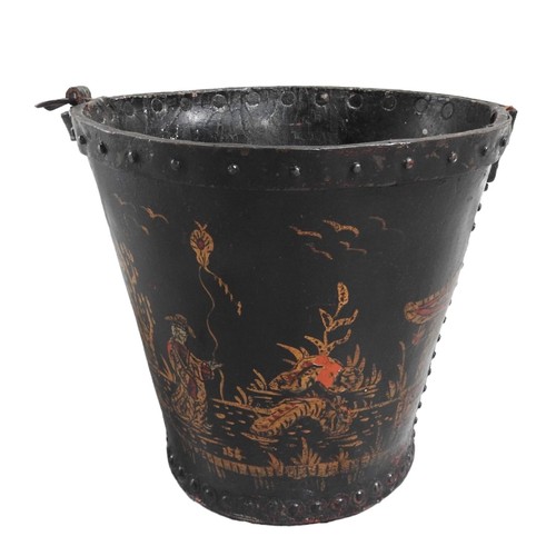 600 - A JAPANNED VINTAGE LEATHER FIRE BUCKET the sides painted with figural landscape and landscape decora... 