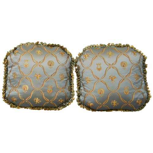 608 - A PAIR OF SILK CUSHIONS depicting golden lyres, cherubs and birds on a silvery blue ground.40cm x 40... 