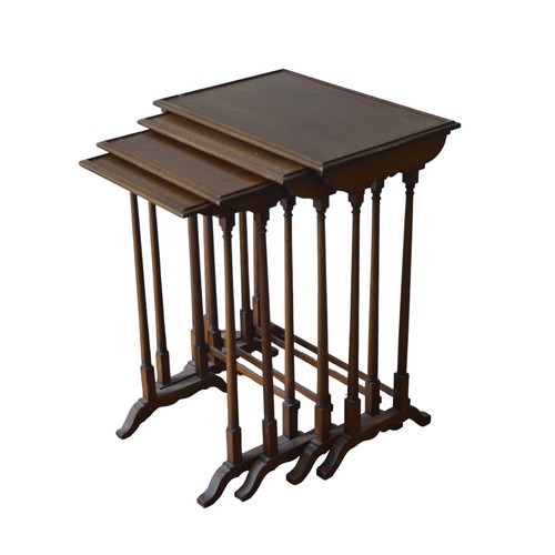 9 - A NEST OF FOUR MAHOGANY CROSS BANDED TABLES, rectangular galleried tops raised on turned legsLargest... 