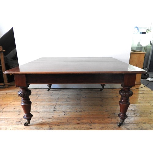 10 - A LARGE MID VICTORIAN MAHOGANY DINING TABLE, the rectangular moulded edge top raised on ring turned ... 