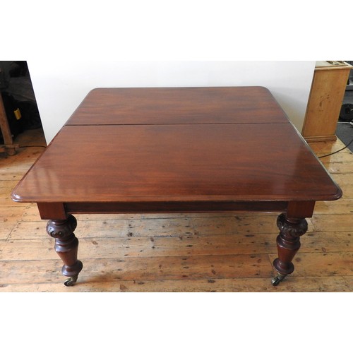 10 - A LARGE MID VICTORIAN MAHOGANY DINING TABLE, the rectangular moulded edge top raised on ring turned ... 