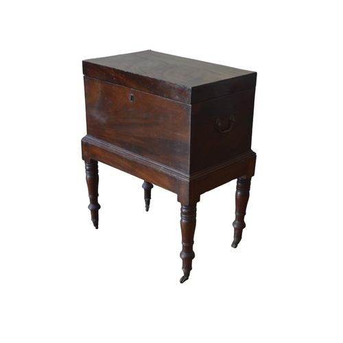 37 - A MAHOGANY CELLARETTE, 19TH CENTURY, the hinged rectangular top opening to reveal a compartmented in... 