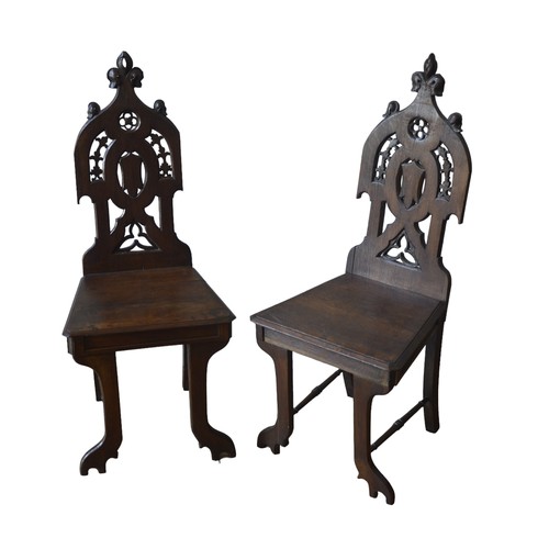 40 - A PAIR OF VICTORIAN OAK GOTHIC REVIVAL HALL CHAIRS, with ornate pierced quatrefoil and cartouche dec... 