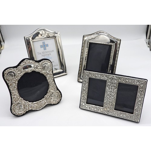 445 - A GROUP OF FOUR SILVER MOUNTED PHOTOGRAPH FRAMES, the lot includes two arch top rectangular frames, ... 