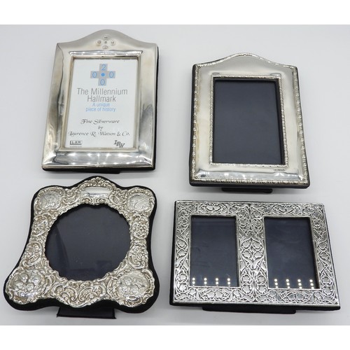 445 - A GROUP OF FOUR SILVER MOUNTED PHOTOGRAPH FRAMES, the lot includes two arch top rectangular frames, ... 