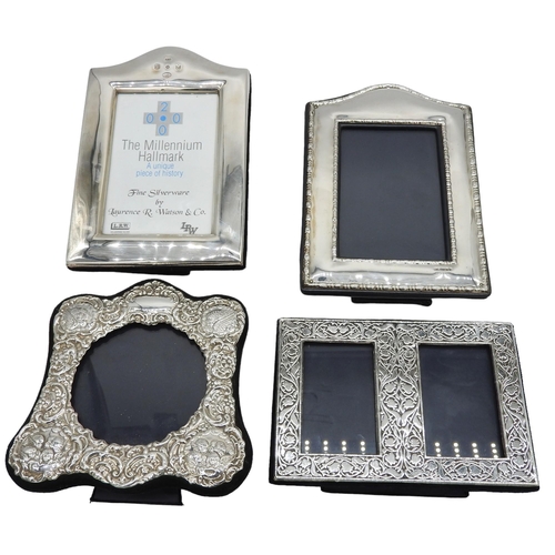 445 - A GROUP OF FOUR SILVER MOUNTED PHOTOGRAPH FRAMES, the lot includes two arch top rectangular frames, ... 