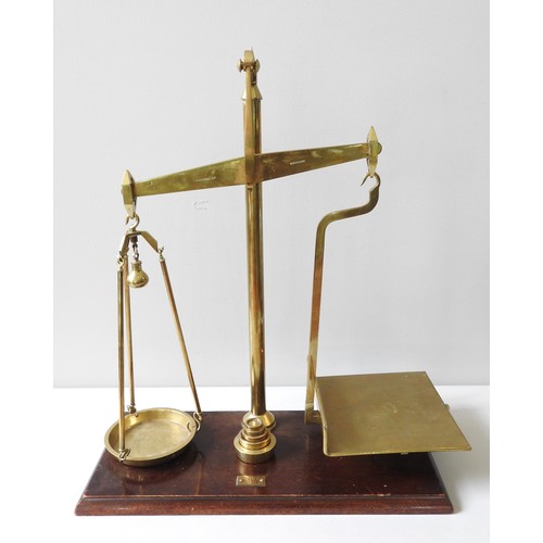 142 - A SET OF VINTAGE BRASS BALANCE SCALES, by C.W Brecknell, Birmingham, raised on a chamfered rectangul... 
