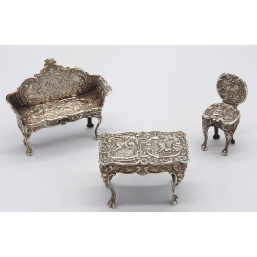 447 - THREE PIECES OF VINTAGE MINIATURE SILVER FURNITURE, the lot comprised of a chair, centre table and s... 