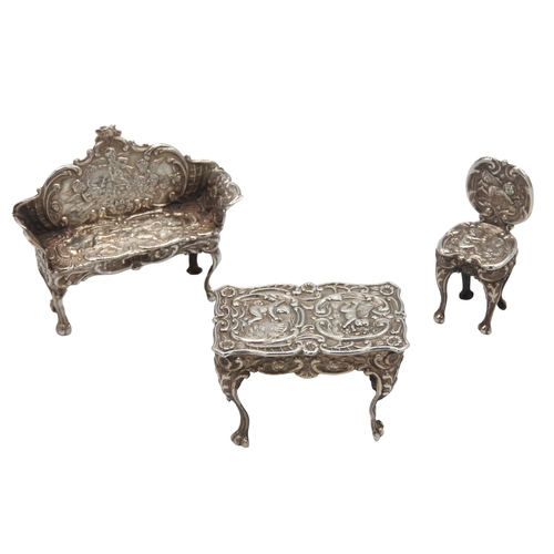 447 - THREE PIECES OF VINTAGE MINIATURE SILVER FURNITURE, the lot comprised of a chair, centre table and s... 