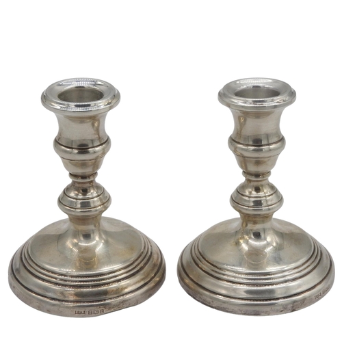 450 - A PAIR OF VINTAGE WEIGHTED SILVER CANDLESTICKS, knopped stem columns on a spreading circular foot, m... 