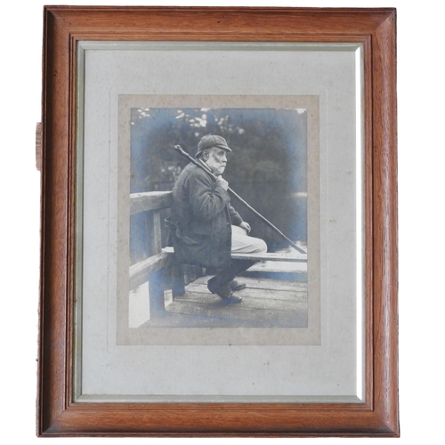 344 - A VINTAGE PORTRAIT PHOTOGRAPH ON GELATIN OF A GAMEKEEPER, glazed and mounted in an oak frame