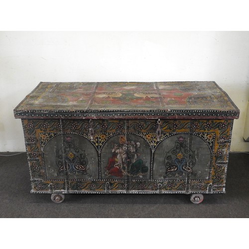114 - A LARGE INDIAN TEAK SANDOOK CHEST, the iron banded teak chest profusely painted with hindu deities a... 