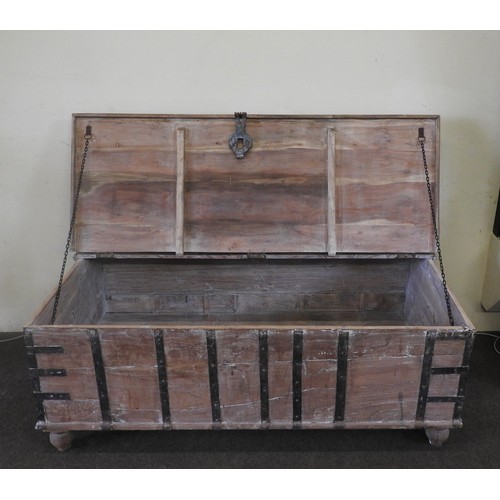 111 - AN INDIAN TEAK SHALLOW TRUNK, with iron banding, raised on turned wooden feet57 x 154 x 52 cmProvena... 