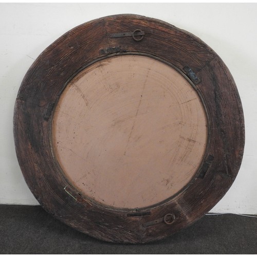 123 - A LARGE INDIAN CIRCULAR HARDWOOD MIRROR, fashioned from an old cartwheel124 cm diamProvenance: Prope... 