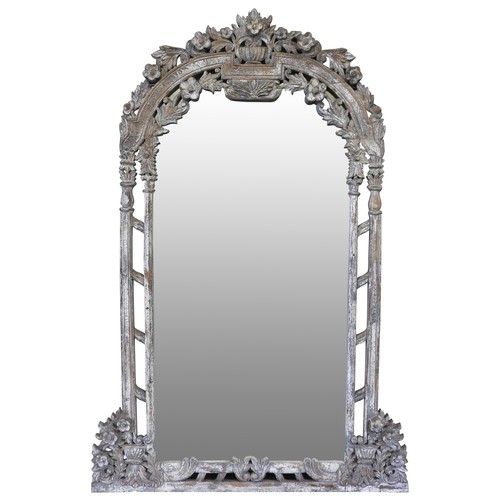 116 - AN INDIAN CHALK PAINTED ARCHED PIER MIRROR, the mirror frame with carved decoration depicting a flut... 