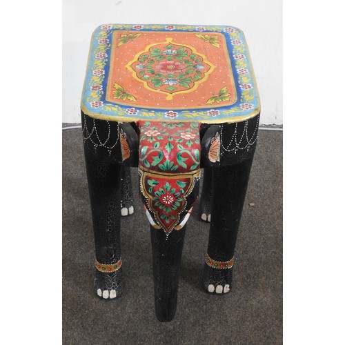 91 - AN INDIAN CARVED PAINTED OCCASIONAL TABLE, in the form of a caparisoned elephant standing foursquare... 