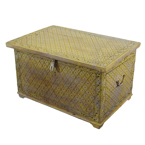 82 - AN INDIAN HARDWOOD TRUNK, painted in a vibrant yellow with a floral lozenge pattern38 x 60 x 40 cmPr... 