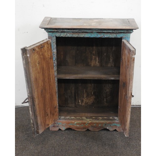80 - AN INDIAN HARDWOOD TWO DOOR TRINKET CUPBOARD, with distressed painted finish69 x 55 x 26 cmProvenanc... 