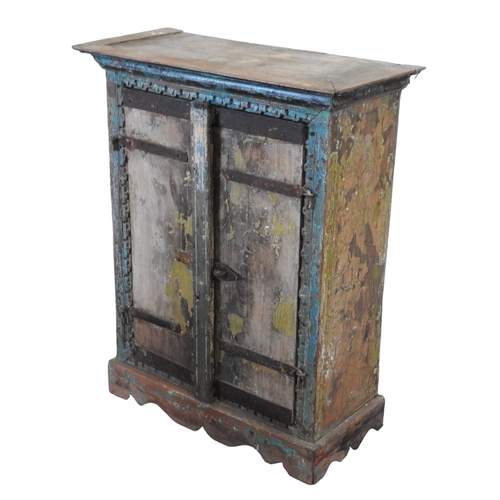 80 - AN INDIAN HARDWOOD TWO DOOR TRINKET CUPBOARD, with distressed painted finish69 x 55 x 26 cmProvenanc... 