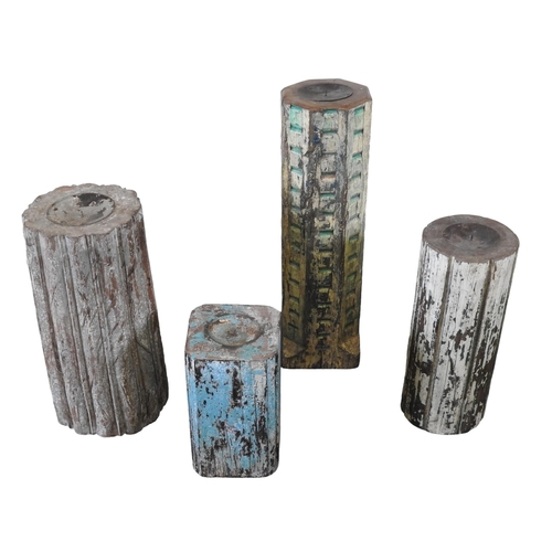 74 - A GROUP OF FOUR LARGE INDIAN TEAK CANDLE STANDS, with attractive distressed painted finishTallest 59... 