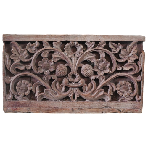 73 - A INDIAN CARVED TEAK PANEL, decorated with carved scrolling flowering stems41.5 x  74 cm Provenance:... 