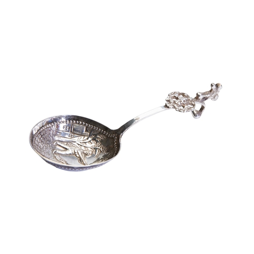 443 - A DUTCH SILVER SUGAR SPOON, the deep bowl with repousse decoration depicting a hunting scene, with a... 