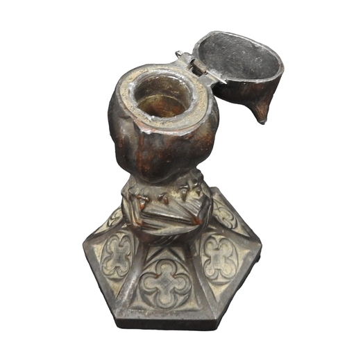 421 - A 19TH CENTURY SPELTER INKWELL, modelled as an owl stood atop a pile of books, raised on a hexagonal... 